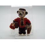 Butler & Wilson - a Butler & Wilson stone set brooch in the form of a teddy bear dressed as a