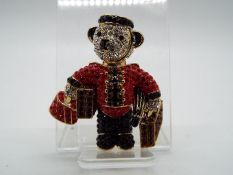 Butler & Wilson - a Butler & Wilson stone set brooch in the form of a teddy bear dressed as a