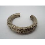 A white metal Asian bangle