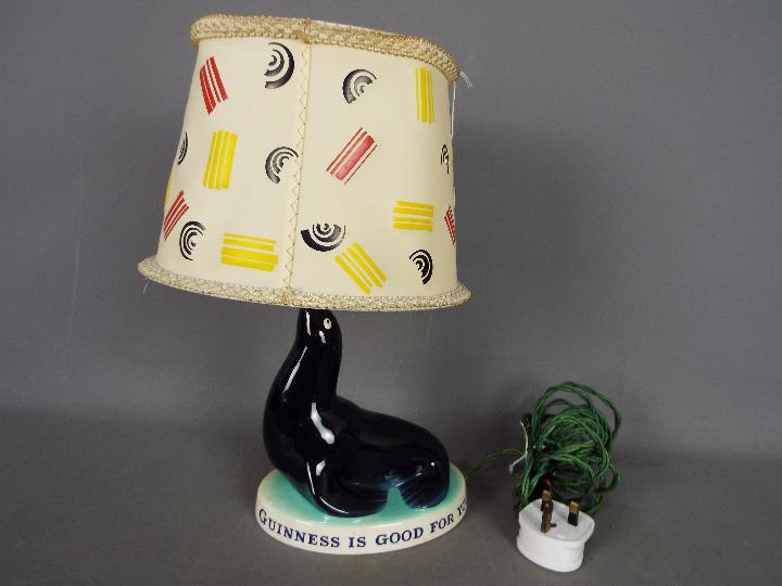 Breweriana - A Guinness advertising table lamp by Carlton Ware modelled as a sealion,