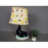 Breweriana - A Guinness advertising table lamp by Carlton Ware modelled as a sealion,
