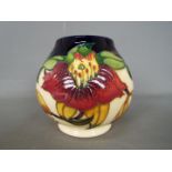 Moorcroft - a Moorcroft vase decorated in the Anna Lily pattern,