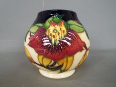 Moorcroft - a Moorcroft vase decorated in the Anna Lily pattern,