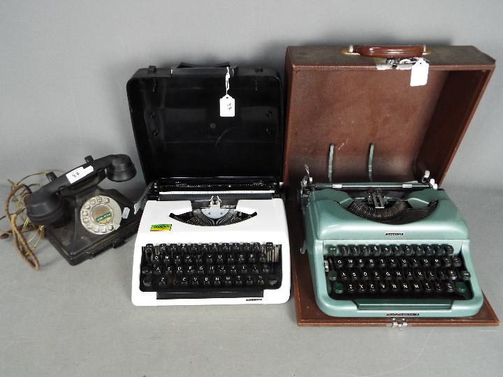 Two portable typewriters, one an Imperial 'Good Companion' and a vintage dial telephone.