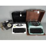 Two portable typewriters, one an Imperial 'Good Companion' and a vintage dial telephone.