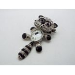Butler & Wilson - a Butler & Wilson stone set brooch in the form of a black and white racoon,
