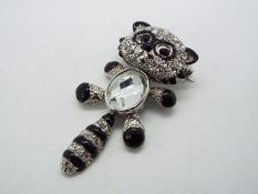 Butler & Wilson - a Butler & Wilson stone set brooch in the form of a black and white racoon,