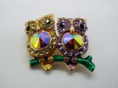 Butler & Wilson - a Butler & Wilson stone set brooch in the form of two owls sitting on a branch,