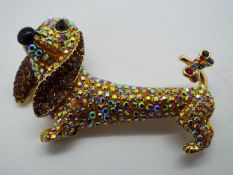 Butler & Wilson - a Butler & Wilson stone set brooch in the form of a dachshund ,