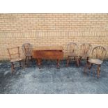 A drop leaf table measuring approximately 74 cm x 106 cm x 50 (104) cm and five chairs.
