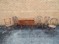 A drop leaf table measuring approximately 74 cm x 106 cm x 50 (104) cm and five chairs.