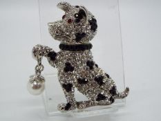 Butler & Wilson - a Butler & Wilson stone set brooch in the form of a sitting dog,