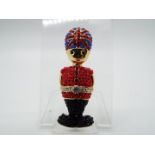 Butler & Wilson - a Butler & Wilson stone set brooch in the form of a Beefeater,