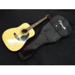 A Spur six string acoustic guitar in case.