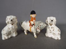 A pair of Staffordshire style Beswick spaniels and a Beswick,