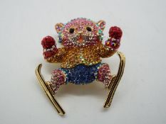 Butler & Wilson - a multicoloured Butler & Wilson stone set brooch in the form of a cat with skis,