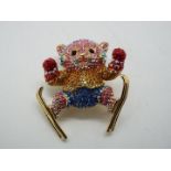 Butler & Wilson - a multicoloured Butler & Wilson stone set brooch in the form of a cat with skis,