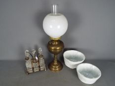 A brass oil lamp with milk glass shade,