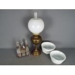 A brass oil lamp with milk glass shade,