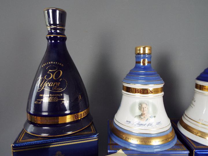 Six commemorative Bells ceramic whisky decanters (with contents) comprising four 70cl and two 50cl, - Image 3 of 4