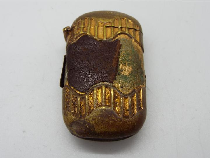 A Victorian brass and leather Vesta case