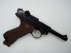 A vintage Japanese airsoft gun in the form of a Luger, model 72, by Falcon.