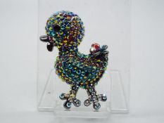 Butler & Wilson - a Butler & Wilson multicoloured stone set brooch in the form of a duckling,
