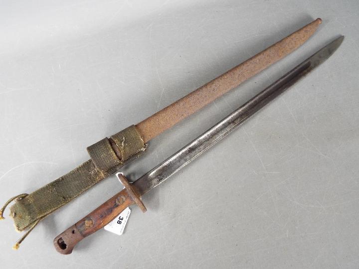 A World War One (WW1 / WWI) sword bayonet, pattern 1907 with steel scabbard, blade 43 cm (l).