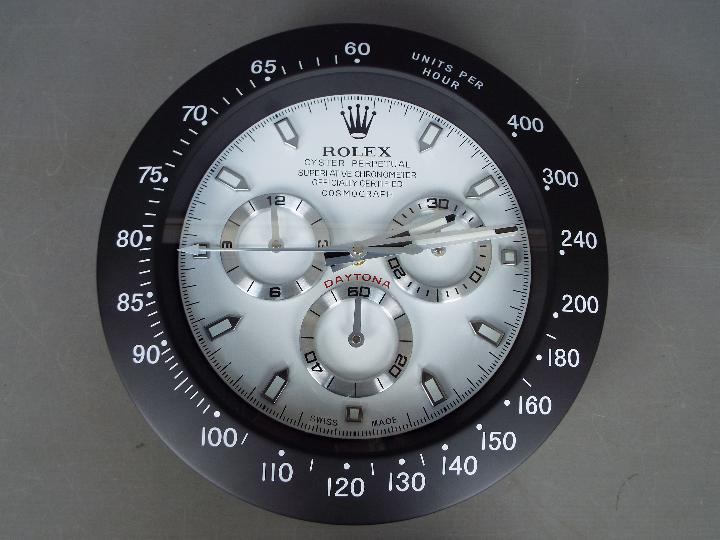 An advertising wall clock in a white and black finish