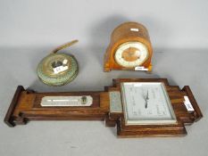 A Smiths mantel clock with key, a wall barometer and one other.