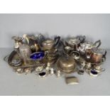 A large quantity of various vintage plated ware comprising trays, cruets, teapots,