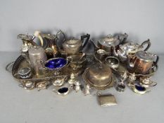 A large quantity of various vintage plated ware comprising trays, cruets, teapots,