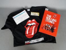 A signed copy of According To The Rolling Stones, signed to the dust jacket and an internal page,