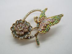 Butler & Wilson - a Butler & Wilson stone set brooch in the form of a butterfly with flower,