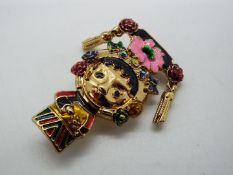 Butler & Wilson - a Butler & Wilson enamel and stone set brooch in the form of a girl,