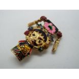 Butler & Wilson - a Butler & Wilson enamel and stone set brooch in the form of a girl,