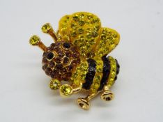 Butler & Wilson - a Butler & Wilson stone set pin in the form of a bee,