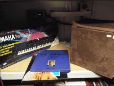 A Yamaha keyboard and a quantity of viny