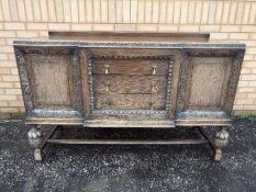 A large highly carved sideboard having t