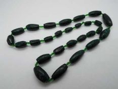 A graduated Malachite green hard stone n