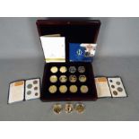 A case containing twelve gold plated com