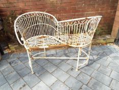 Garden furniture - a white painted metal love seat / kissing seat,