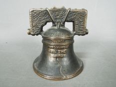 A vintage, cast iron, American novelty money bank, in the form of the Liberty Bell,