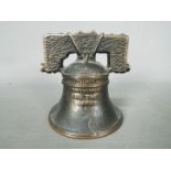 A vintage, cast iron, American novelty money bank, in the form of the Liberty Bell,