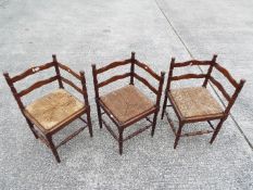 Three corner chairs with turned supports and rush seats.