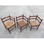 Three corner chairs with turned supports and rush seats.