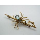 9ct - a 9ct bar brooch decorated with a stone set spider design and safety chain, 6.