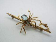 9ct - a 9ct bar brooch decorated with a stone set spider design and safety chain, 6.