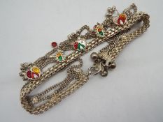 An ornate white metal necklace