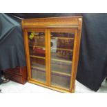 A good quality bookcase with twin glazed doors and carved detailing,
